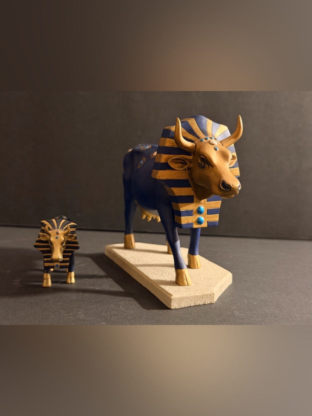 A set of two Cow Parade Tutancowmon figurines with Egyptian-inspired decoration.